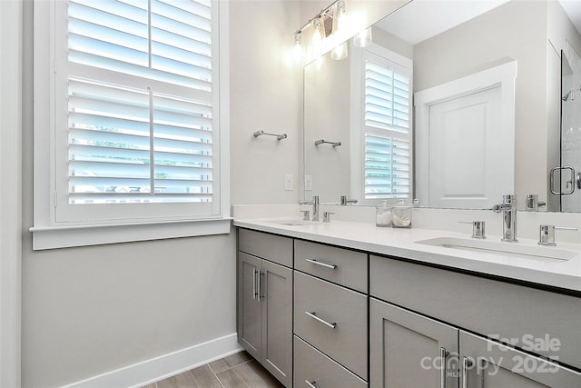 5129 Whitman Ave, Matthews, NC 28105 - full bath with double vanity, wood finished floors, and an enclosed shower