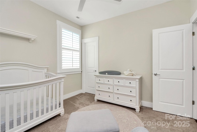 5129 Whitman Ave, Matthews, NC 28105 - bedroom with light colored carpet, a crib, and a ceiling fan