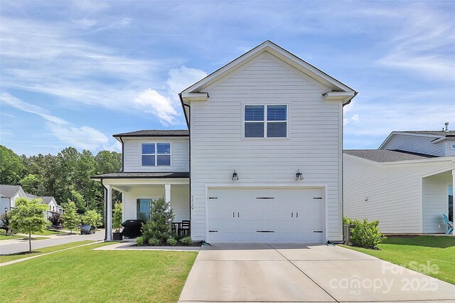 5129 Whitman Ave, Matthews, NC 28105 - traditional-style house with a garage, driveway, a front lawn, and covered porch