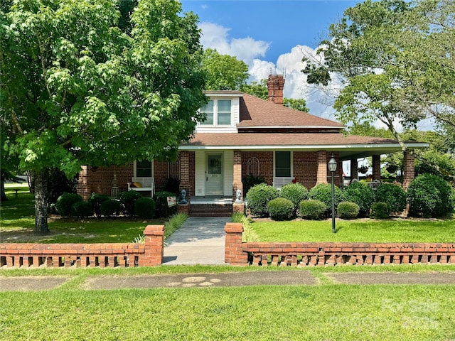 300 Blackmon St S, Bethune, SC 29009 - view of front of property featuring a front lawn, a shingled roof, and brick siding