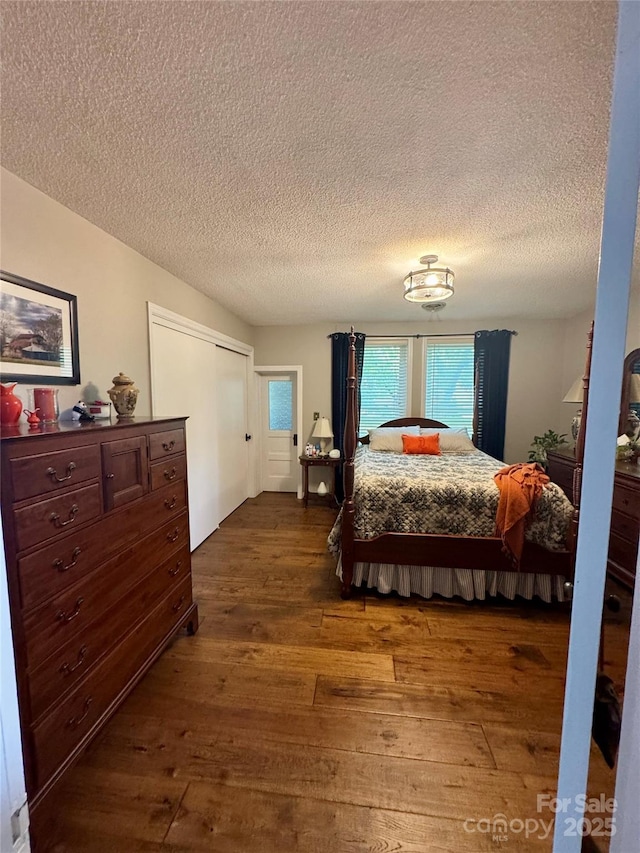 300 Blackmon St S, Bethune, SC 29009 - bedroom with dark wood-style flooring, a textured ceiling, and a closet