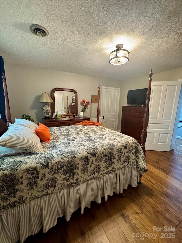 300 Blackmon St S, Bethune, SC 29009 - bedroom with wood finished floors and a textured ceiling
