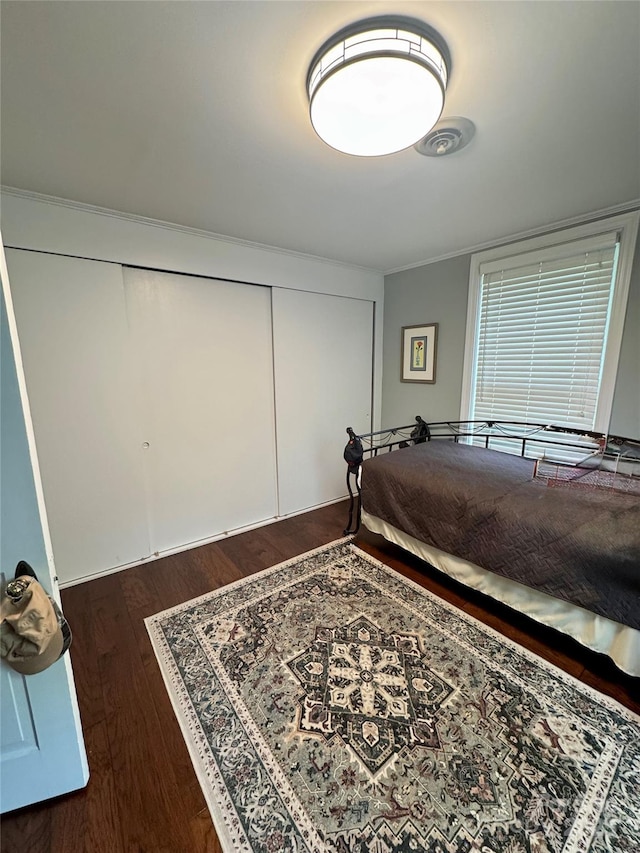 300 Blackmon St S, Bethune, SC 29009 - bedroom with dark wood-style flooring, a closet, and ornamental molding