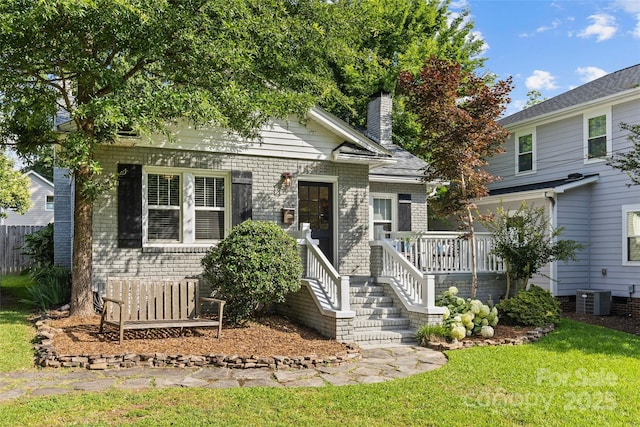 3035 Florida Ave, Charlotte, NC 28205 - view of front of property with a front yard, a chimney, and brick siding