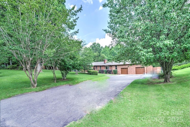 4004 Stillwater Ct, York, SC 29745 - view of front of home featuring driveway, an attached garage, a front yard, and a chimney