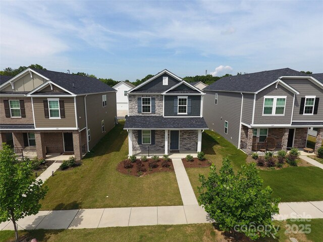 125 Cedar Knoll Cir, Pineville, NC 28134 - craftsman-style house with stone siding, covered porch, a front lawn, and a residential view
