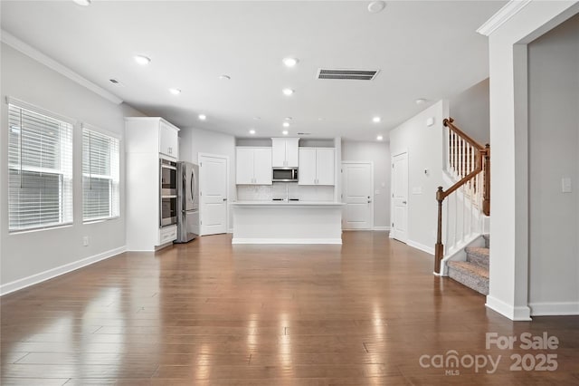 125 Cedar Knoll Cir, Pineville, NC 28134 - unfurnished living room with stairs, recessed lighting, dark wood-style flooring, and ornamental molding