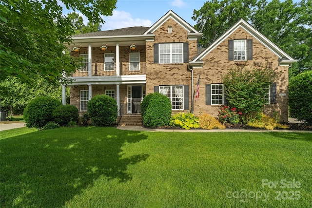 1812 Mill Chase Ln, Waxhaw, NC 28173 - view of front of house with brick siding, a balcony, and a front lawn