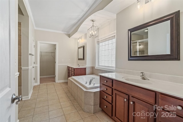 1812 Mill Chase Ln, Waxhaw, NC 28173 - bathroom featuring two vanities, a chandelier, tile patterned flooring, a bath, and crown molding