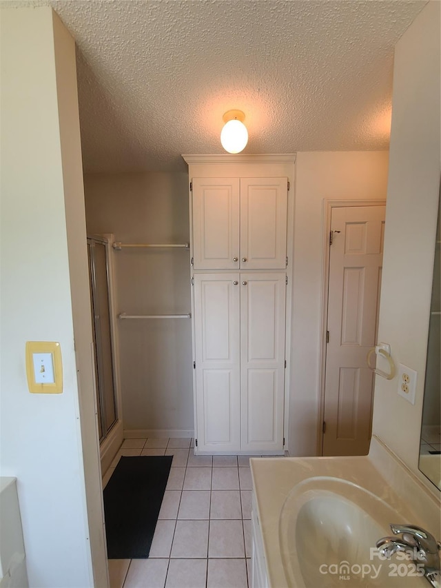 110 Kimberly Ln, Kings Mountain, NC 28086 - full bath with tile patterned flooring, an enclosed shower, a textured ceiling, and vanity