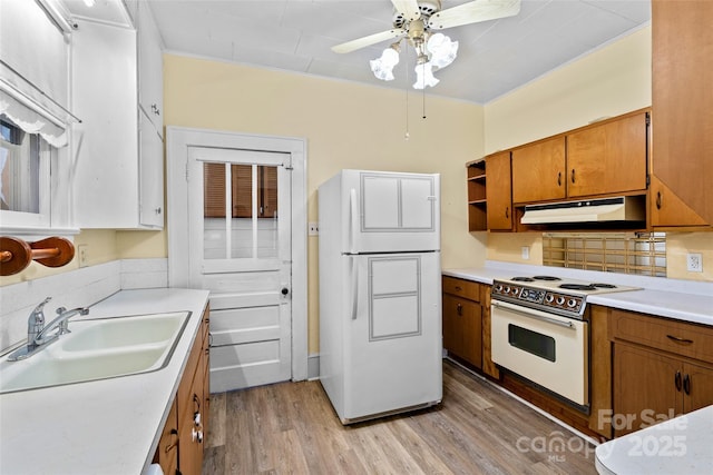 23 Oteen Park Pl, Asheville, NC 28805 - kitchen with white appliances, under cabinet range hood, brown cabinets, and light wood finished floors