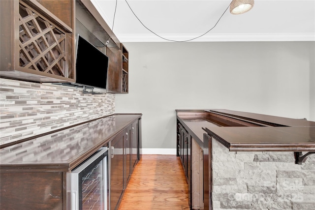 2275 Laurens Dr, Concord, NC 28027 - bar featuring crown molding, beverage cooler, light wood-style floors, and decorative backsplash