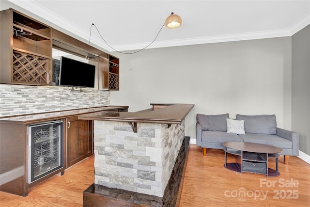 2275 Laurens Dr, Concord, NC 28027 - indoor dry bar with crown molding, tasteful backsplash, light wood finished floors, and wine cooler