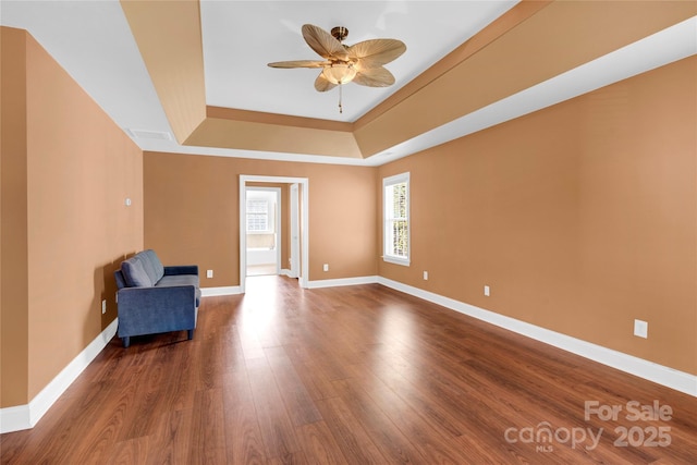 2275 Laurens Dr, Concord, NC 28027 - unfurnished room with a raised ceiling, wood finished floors, and ceiling fan
