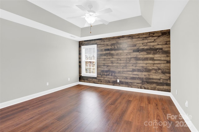 2275 Laurens Dr, Concord, NC 28027 - spare room featuring a ceiling fan, wood finished floors, and a tray ceiling
