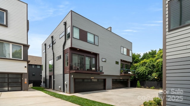 1011 Westbrook Dr Unit A, Charlotte, NC 28202 - contemporary home with driveway, a garage, and a balcony