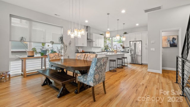 1011 Westbrook Dr Unit A, Charlotte, NC 28202 - dining room featuring light wood finished floors, recessed lighting, and a chandelier