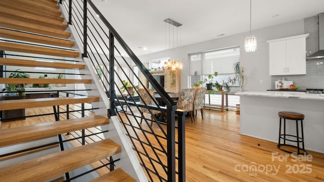 1011 Westbrook Dr Unit A, Charlotte, NC 28202 - stairway with wood finished floors and a chandelier