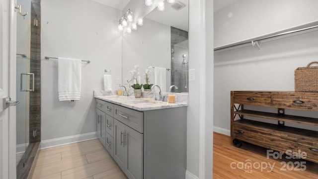 1011 Westbrook Dr Unit A, Charlotte, NC 28202 - full bath featuring double vanity, a stall shower, and wood finished floors