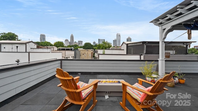 1011 Westbrook Dr Unit A, Charlotte, NC 28202 - patio / terrace with a fire pit and a view of skyline