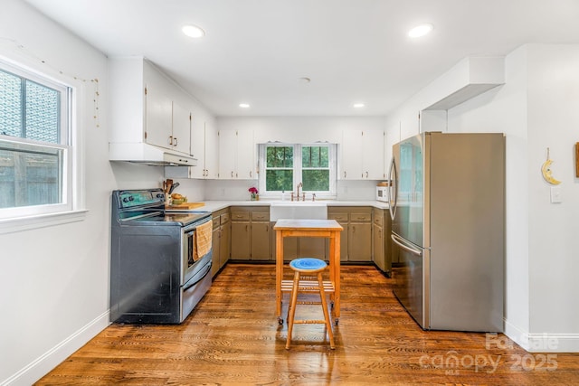 99 Little Oak St, Canton, NC 28716 - kitchen with appliances with stainless steel finishes, under cabinet range hood, dark wood-type flooring, recessed lighting, and light countertops