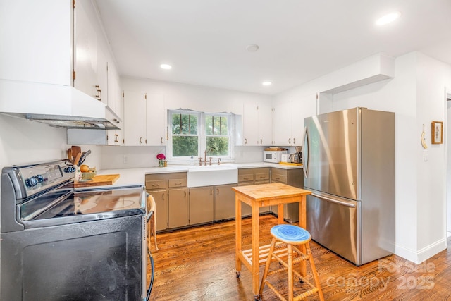 99 Little Oak St, Canton, NC 28716 - kitchen featuring freestanding refrigerator, electric range oven, light wood-style flooring, light countertops, and recessed lighting