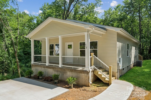 54 Reed St NE, Concord, NC 28025 - view of front of house with covered porch, crawl space, and a front lawn
