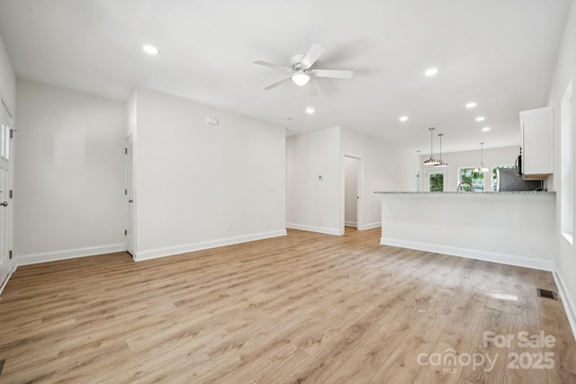 54 Reed St NE, Concord, NC 28025 - unfurnished living room featuring a ceiling fan, light wood-type flooring, and recessed lighting