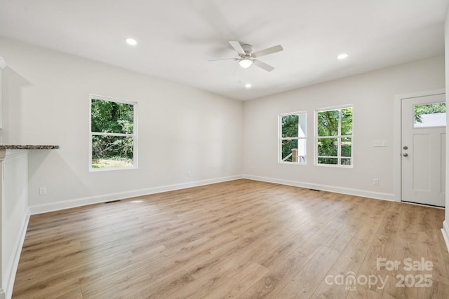 54 Reed St NE, Concord, NC 28025 - unfurnished living room featuring ceiling fan, light wood-style floors, and recessed lighting