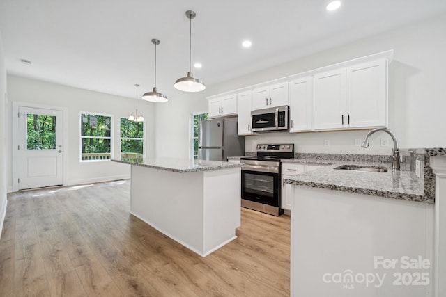 54 Reed St NE, Concord, NC 28025 - kitchen with appliances with stainless steel finishes, light wood-type flooring, white cabinets, and recessed lighting