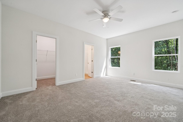 54 Reed St NE, Concord, NC 28025 - unfurnished bedroom featuring a spacious closet, carpet floors, ceiling fan, a closet, and ensuite bath