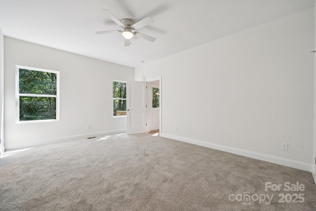 54 Reed St NE, Concord, NC 28025 - spare room featuring a ceiling fan, healthy amount of natural light, and carpet flooring