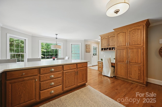4824 Waxhaw Farms Rd, Waxhaw, NC 28173 - kitchen featuring crown molding, brown cabinets, light countertops, and dark wood-style flooring
