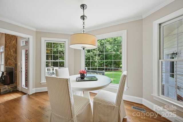 4824 Waxhaw Farms Rd, Waxhaw, NC 28173 - dining room with light wood-type flooring and crown molding