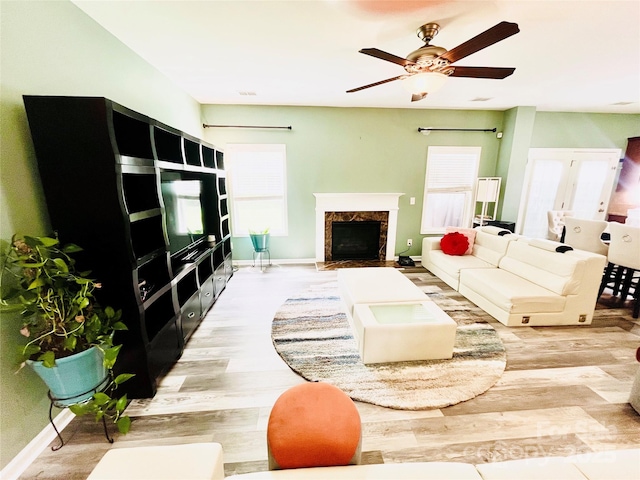 9792 Ravenscroft Ln NW, Concord, NC 28027 - living area featuring light wood-type flooring, a fireplace, and a ceiling fan