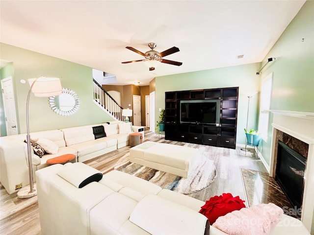 9792 Ravenscroft Ln NW, Concord, NC 28027 - living area featuring wood finished floors, stairs, ceiling fan, and a premium fireplace