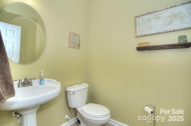 9792 Ravenscroft Ln NW, Concord, NC 28027 - bathroom featuring toilet and baseboards
