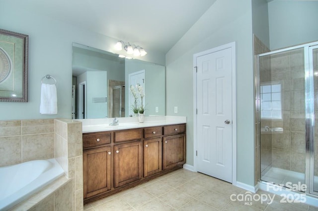 9792 Ravenscroft Ln NW, Concord, NC 28027 - full bath featuring vanity, a garden tub, a stall shower, and tile patterned flooring