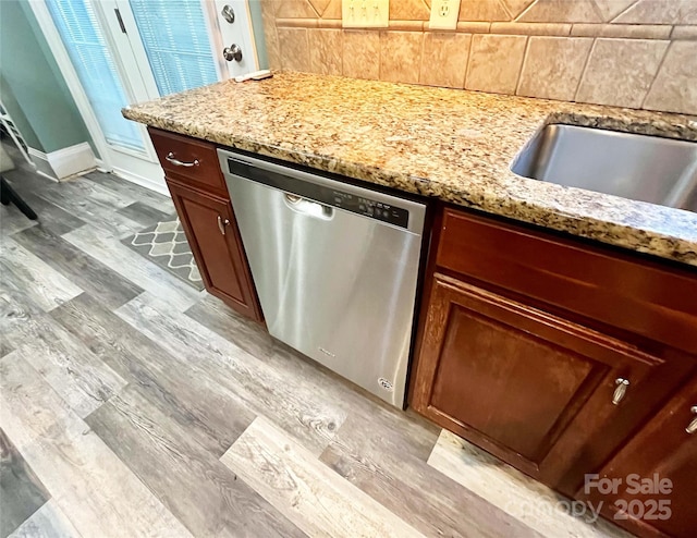 9792 Ravenscroft Ln NW, Concord, NC 28027 - kitchen with stainless steel dishwasher, backsplash, light wood finished floors, and light stone counters