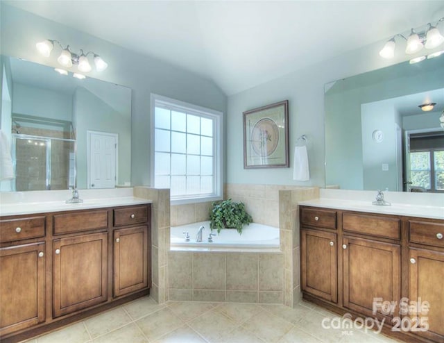 9792 Ravenscroft Ln NW, Concord, NC 28027 - full bath featuring two vanities, a stall shower, a bath, tile patterned flooring, and lofted ceiling