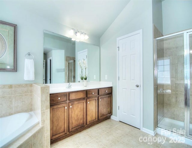 9792 Ravenscroft Ln NW, Concord, NC 28027 - bathroom with vanity, a garden tub, a stall shower, and tile patterned flooring