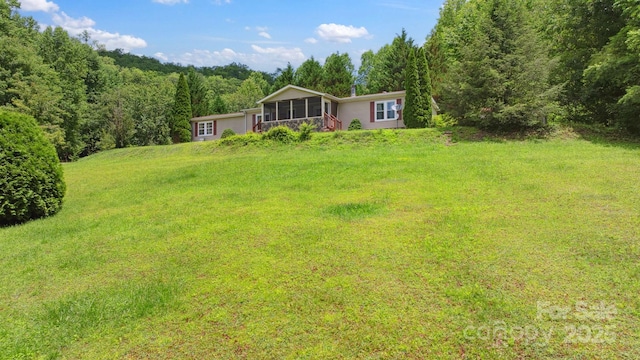 152 Lantana Dr, Sylva, NC 28779 - view of grassy yard featuring a sunroom and a forest view