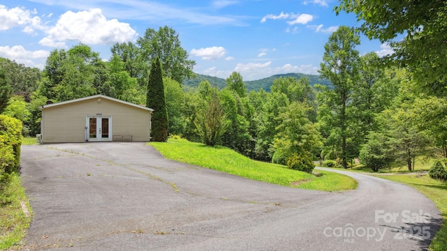 152 Lantana Dr, Sylva, NC 28779 - view of home's exterior with french doors, driveway, a view of trees, and a mountain view