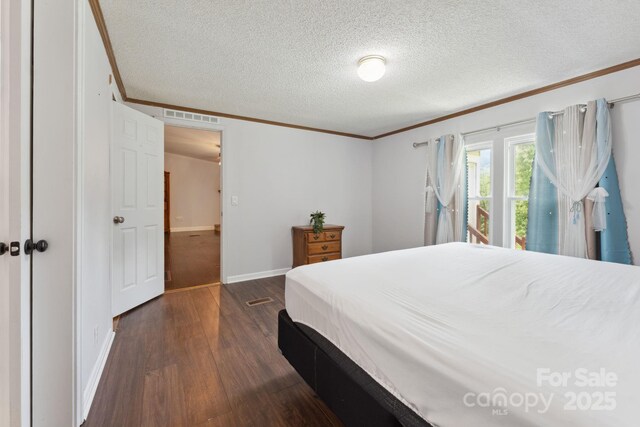 152 Lantana Dr, Sylva, NC 28779 - bedroom featuring crown molding, dark wood finished floors, and a textured ceiling