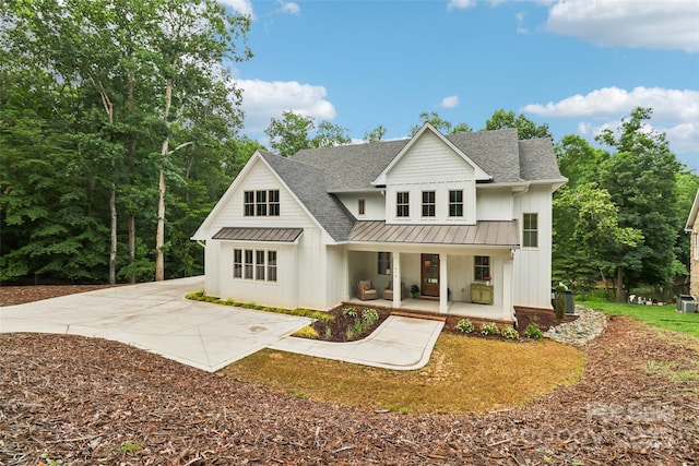416 Plantation Way Unit 3, Mount Gilead, NC 27306 - back of house featuring covered porch, a standing seam roof, a shingled roof, board and batten siding, and a metal roof