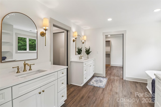 416 Plantation Way Unit 3, Mount Gilead, NC 27306 - full bath with two vanities, wood finished floors, recessed lighting, and a freestanding tub
