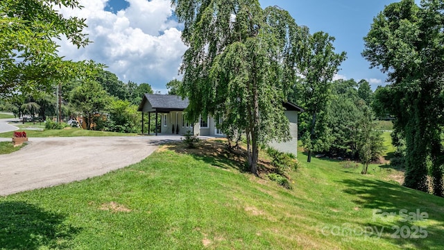 191 Harmony Grove Rd, Nebo, NC 28761 - obstructed view of property with asphalt driveway, a front yard, and a carport