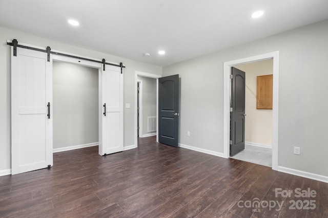 191 Harmony Grove Rd, Nebo, NC 28761 - unfurnished bedroom with a barn door, wood finished floors, recessed lighting, and ensuite bathroom