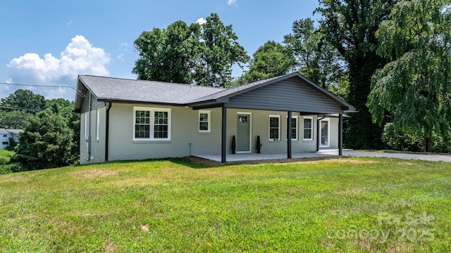 191 Harmony Grove Rd, Nebo, NC 28761 - back of property with a patio area, brick siding, and a yard