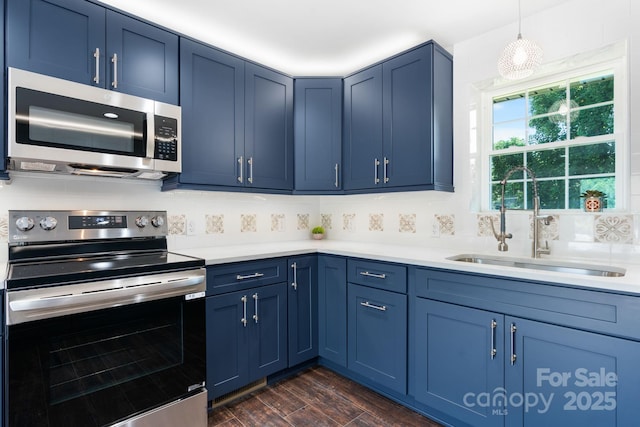 191 Harmony Grove Rd, Nebo, NC 28761 - kitchen featuring stainless steel appliances, blue cabinets, light countertops, and backsplash